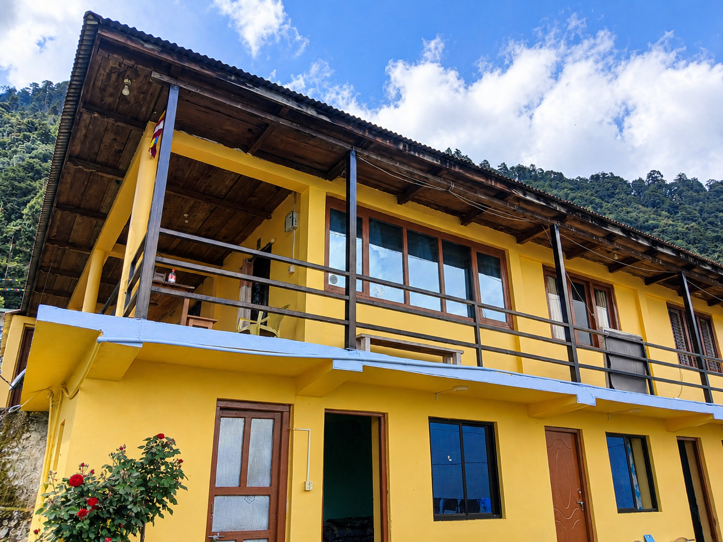 Wooden veranda overlooking green Himalayan mountains